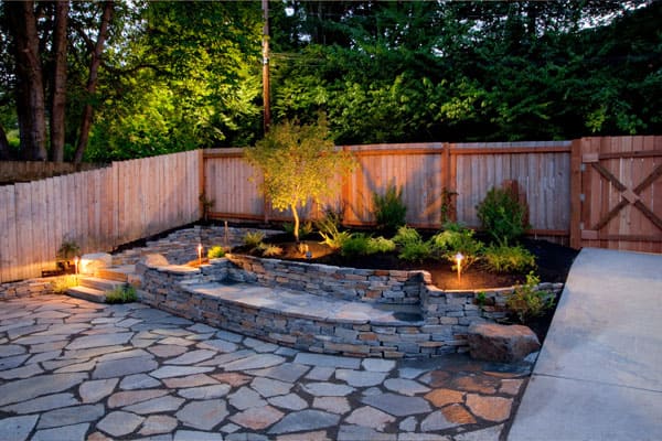 Before and after of hillside hardscape project in Agoura Hills showing retaining walls and patio